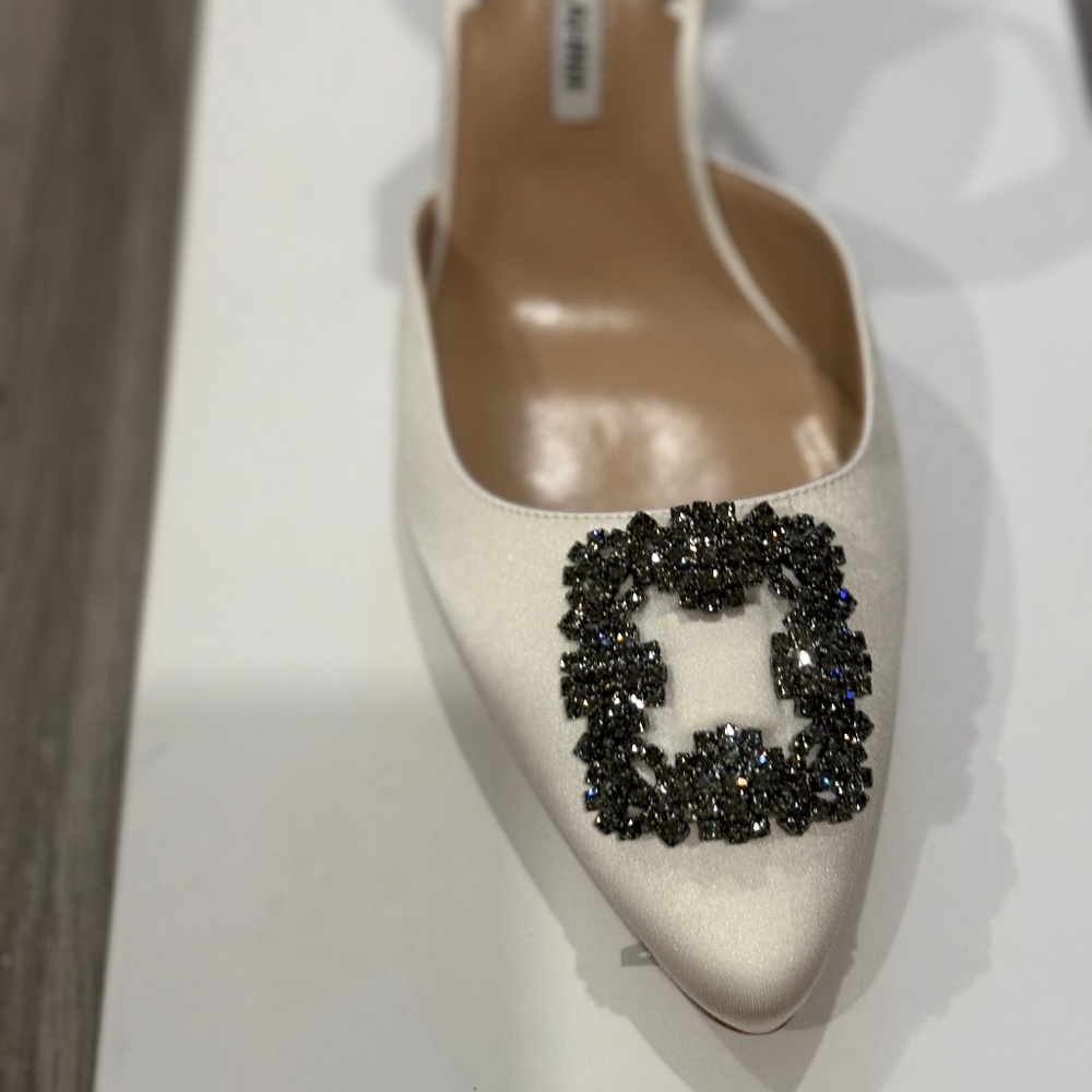 Cream Satin Manolo Blahnik with strap heel.